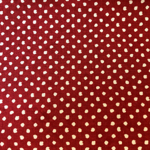 Red fabric with small white polka dots